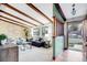 Bright living room with exposed wood beams, large windows, neutral decor, and an open floor plan at 7290 Lamar Ct, Arvada, CO 80003