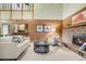 Inviting living room featuring a brick fireplace, soft seating and wooden paneling at 7290 Lamar Ct, Arvada, CO 80003