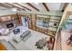 Bright, airy living room boasts high ceilings, exposed beams and a custom bookcase at 7290 Lamar Ct, Arvada, CO 80003