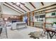 Sun-filled living room with vaulted ceilings, exposed beams, and fireplace at 7290 Lamar Ct, Arvada, CO 80003