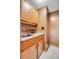Convenient wet bar featuring wood cabinets, granite countertop and modern fixtures at 7290 Lamar Ct, Arvada, CO 80003