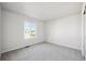 Bright bedroom with carpeted floor and large window at 1322 Bloom St, Brighton, CO 80601