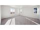 Bright bedroom with grey carpet and large windows at 1322 Bloom St, Brighton, CO 80601