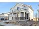 Two-story house with gray siding, white trim, and a two-car garage at 1322 Bloom St, Brighton, CO 80601