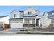 Two-story house with gray siding, white trim, and a two-car garage at 1322 Bloom St, Brighton, CO 80601
