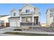 Two-story house with gray siding, white trim, and a two-car garage at 1322 Bloom St, Brighton, CO 80601