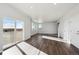 Spacious living room with hardwood floors and sliding glass doors at 1322 Bloom St, Brighton, CO 80601