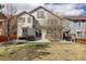 Back of home with patio, table, grill, lawn, and mature trees at 4542 Valleybrook Dr, Highlands Ranch, CO 80130