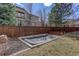 Backyard with built-in trampoline, planters, wood fence, and green space at 4542 Valleybrook Dr, Highlands Ranch, CO 80130