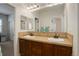 Bathroom features a double vanity, granite countertop, and a large mirror at 4542 Valleybrook Dr, Highlands Ranch, CO 80130
