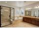 Bathroom boasts a glass-enclosed shower, soaking tub, and dual sink vanity at 4542 Valleybrook Dr, Highlands Ranch, CO 80130