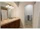 Bathroom with a tiled counter, decorative lighting, and arched shower entry at 4542 Valleybrook Dr, Highlands Ranch, CO 80130