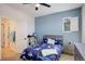 Bedroom boasts a window view, shark-themed bedding, and blue accent wall at 4542 Valleybrook Dr, Highlands Ranch, CO 80130