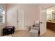 Light pink bedroom with a reading nook with chair, basket, and small table and chairs at 4542 Valleybrook Dr, Highlands Ranch, CO 80130