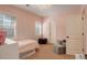 Light pink bedroom with a reading nook with chair, basket, and small table and chairs at 4542 Valleybrook Dr, Highlands Ranch, CO 80130