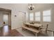 Bright dining room with natural light, chandelier, table with bench and chairs, and hardwood floors at 4542 Valleybrook Dr, Highlands Ranch, CO 80130