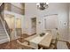 Open-concept dining area with staircase, chandelier, and ample natural light, showcasing a Gathering-friendly layout at 4542 Valleybrook Dr, Highlands Ranch, CO 80130