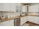 Stylish kitchen featuring white cabinets, stone countertops, modern appliances, and ample counter space at 4542 Valleybrook Dr, Highlands Ranch, CO 80130