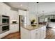 Bright kitchen with island, stainless steel appliances, gas range, and an open floor plan layout at 4542 Valleybrook Dr, Highlands Ranch, CO 80130