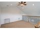 Carpeted loft space with neutral walls, metal railing, and recessed lighting at 4542 Valleybrook Dr, Highlands Ranch, CO 80130