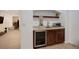 Basement wet bar features cabinets, drink cooler, sink, and open access at 4542 Valleybrook Dr, Highlands Ranch, CO 80130