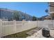Fenced back yard with patio and air conditioning unit. Adjacent to neighboring buildings at 18954 E 57Th Pl # D, Denver, CO 80249
