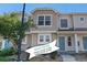 Inviting multi-level townhouse with neutral siding, pretty landscaping, and a charming blue front door at 18954 E 57Th Pl # D, Denver, CO 80249