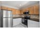Well-appointed kitchen features stainless steel appliances, stylish countertops, and updated cabinetry at 18954 E 57Th Pl # D, Denver, CO 80249