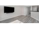 Inviting living room features stylish wood-look flooring, neutral walls, and a wall-mounted television at 18954 E 57Th Pl # D, Denver, CO 80249
