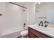 Bathroom featuring bathtub with shower, white tile, modern vanity, and modern fixtures at 6391 Cristobal Pt, Parker, CO 80134