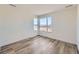 Bright bedroom featuring attractive wood-look flooring and a window at 6391 Cristobal Pt, Parker, CO 80134