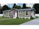 Attractive single-story home with a warm earth-toned exterior, white trim, well-kept lawn, and welcoming entryway at 154 Grove St, Denver, CO 80219