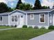 Charming single-story home featuring a light gray exterior, white trim, manicured lawn, and inviting entrance at 154 Grove St, Denver, CO 80219