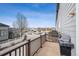 Balcony view overlooking a street with lush trees and a barbecue grill, perfect for outdoor cooking and relaxation at 4108 W 118Th Pl, Westminster, CO 80031