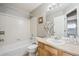 Bathroom with white tiled shower/tub, sink, vanity and cotton plant decoration at 4108 W 118Th Pl, Westminster, CO 80031