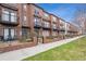 Brick townhome complex with black wrought iron railings and balconies, fronted by green lawns and sidewalks at 4108 W 118Th Pl, Westminster, CO 80031