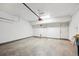 Spacious garage with concrete floors and white painted walls with two entry doors at 4108 W 118Th Pl, Westminster, CO 80031