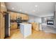 Bright kitchen features an island, stainless steel appliances, wooden cabinets and an open layout to the living room at 4108 W 118Th Pl, Westminster, CO 80031
