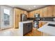 Modern kitchen with stainless steel appliances, light wood cabinets, and white countertops at 4108 W 118Th Pl, Westminster, CO 80031