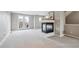 Spacious carpeted living area featuring a modern fireplace and balcony access through double doors at 4108 W 118Th Pl, Westminster, CO 80031