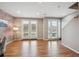 Bright living area with brick accent wall, hardwood floors, and double doors to the outside at 4108 W 118Th Pl, Westminster, CO 80031