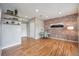 Bright office space featuring brick accent wall, floating shelves and hardwood floors at 4108 W 118Th Pl, Westminster, CO 80031