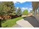 Spacious backyard with a concrete patio, grassy area, and wood fence at 20293 E Progress Pl, Centennial, CO 80015