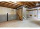 Unfinished basement showcasing the blank canvas for customization with a staircase leading upwards and exposed wooden beams overhead at 20293 E Progress Pl, Centennial, CO 80015