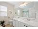 Bright bathroom with dual sinks, a large mirror, and a glass-enclosed shower at 20293 E Progress Pl, Centennial, CO 80015