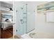 Modern bathroom featuring a glass shower enclosure and access to the bedroom at 20293 E Progress Pl, Centennial, CO 80015