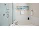 Modern bathroom with a glass-enclosed shower and soaking tub at 20293 E Progress Pl, Centennial, CO 80015