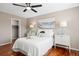 Bright bedroom with hardwood floors, a ceiling fan, and a walk-in closet at 20293 E Progress Pl, Centennial, CO 80015