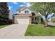 Charming two-story home featuring a well-maintained lawn, a two-car garage, and a welcoming front porch at 20293 E Progress Pl, Centennial, CO 80015