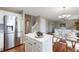 Eat-in kitchen featuring stainless steel appliances, an island, and an adjacent living space at 20293 E Progress Pl, Centennial, CO 80015